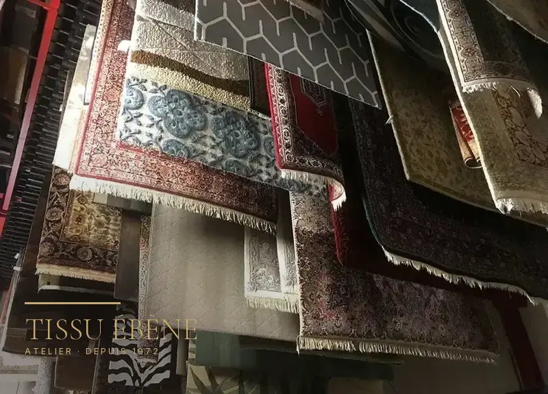 Empilement de tapis d&rsquo;Orient à motifs floraux et géométriques, franges et bordures visibles